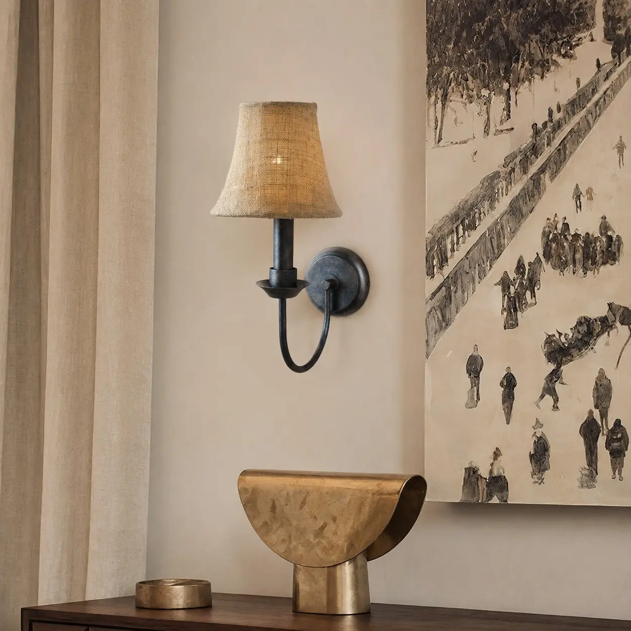 Fabric wall sconce beside framed wall art